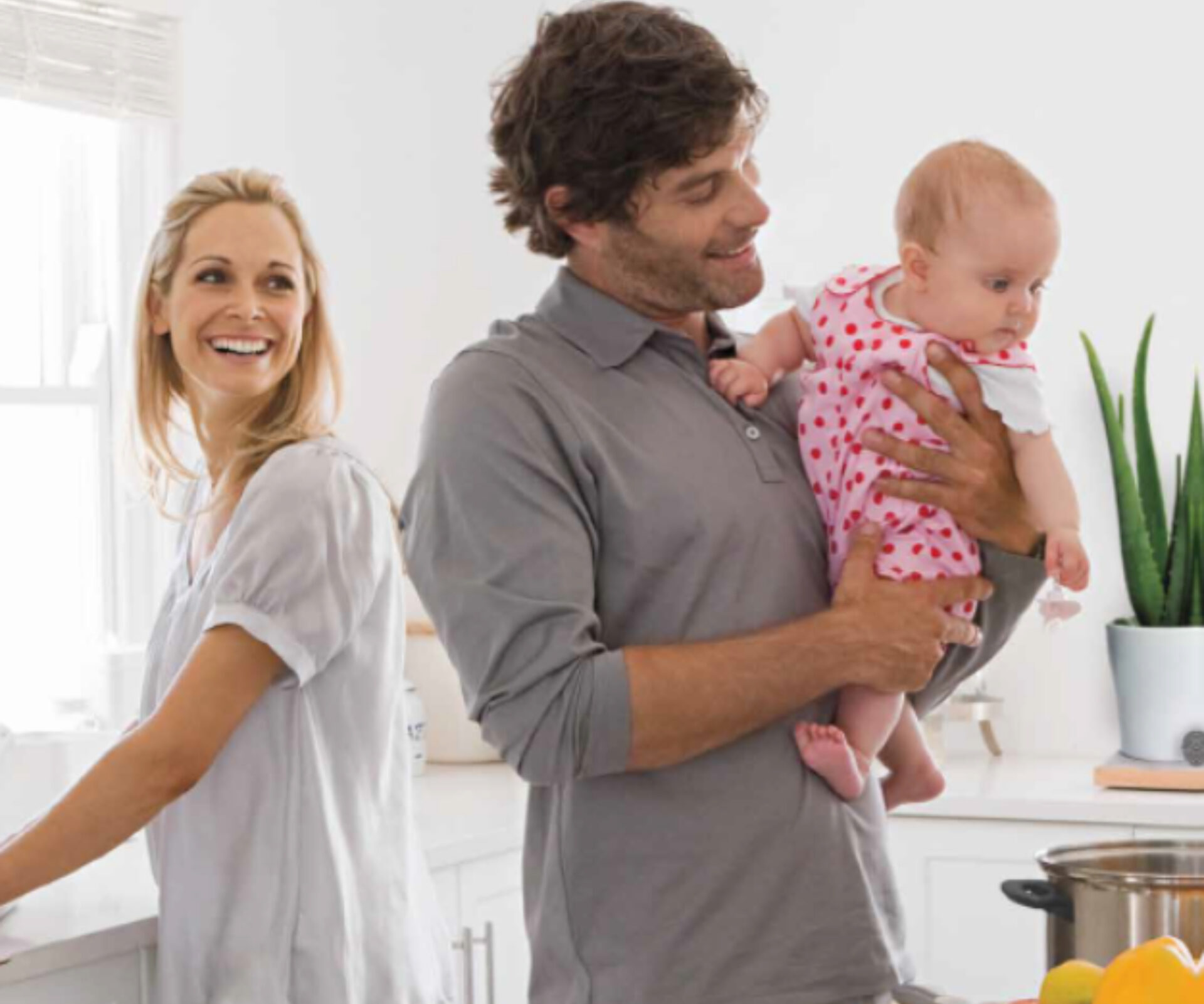 A man is standing and holding his baby girl