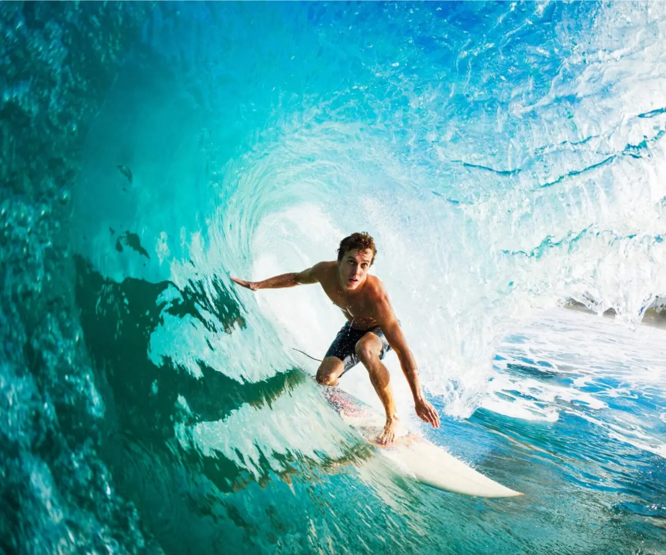 A man standing on the swim board in the ocean