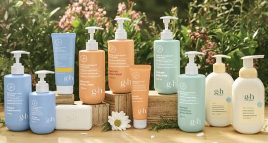 A collection of skincare products with natural ingredients displayed outdoors.