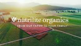 Aerial view of organic farms with the text Nutrilite Organic overlayed.
